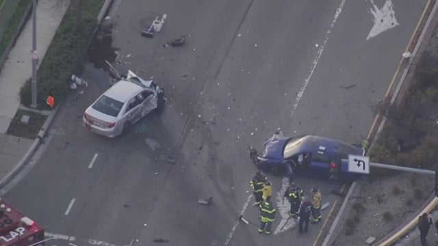 Two damaged vehicles on a roadway 