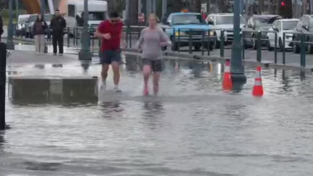 Waves crash against concrete barriers 