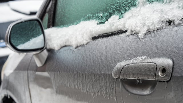 Car handle, mirror and window after freezing rain. 