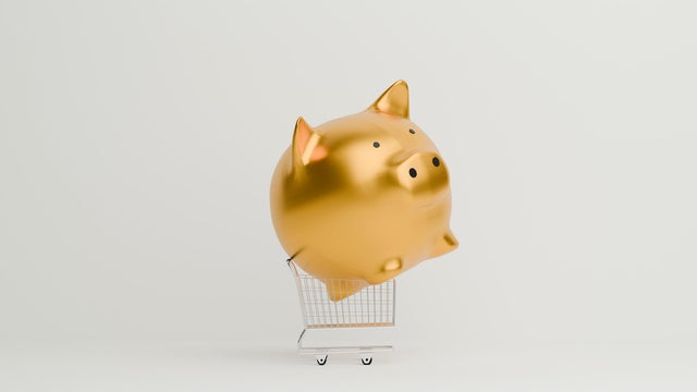 Golden Piggy bank on shopping cart 