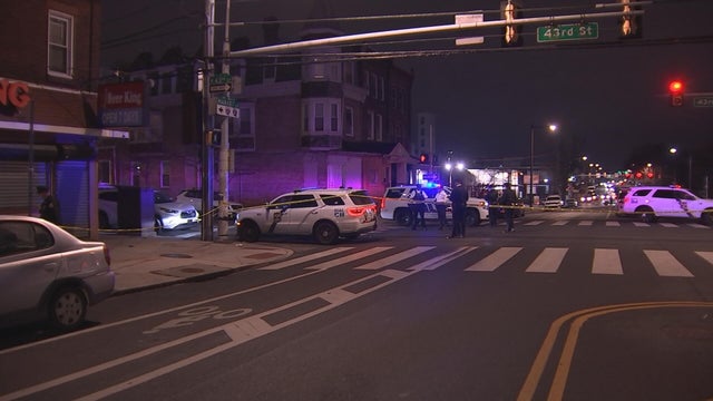 Close Up Shot Focused on Yellow Tape Showing Text Police Line Do Not Cross. Restricted Area of a Crime Scene. Bokeh Background with Flickering Siren Lights. Forensics Team Working on a Case 