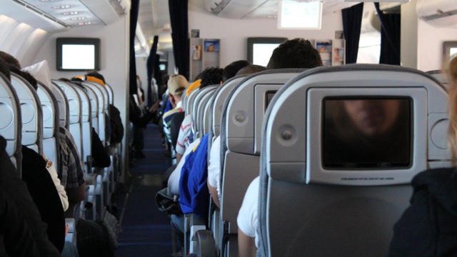 Passengers on a plane wait for takeoff. 