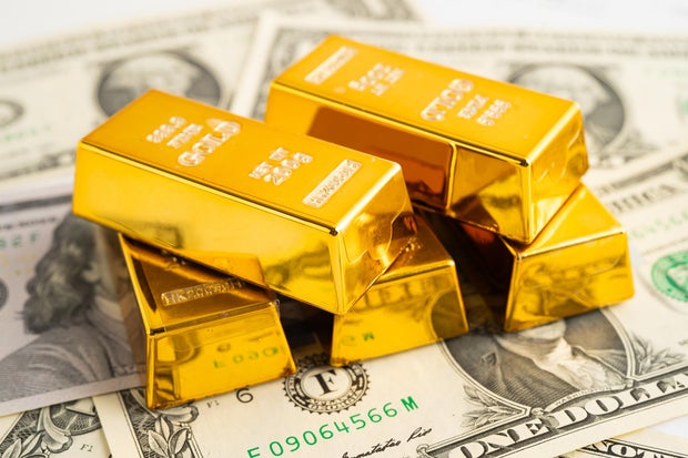 Gold bars with US dollar banknote money, finance trading investment business currency. 