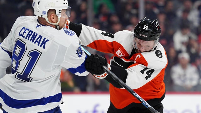 Philadelphia Flyers' Sean Couturier (14) checks Tampa Bay Lightning's Erik Cernak (81) during the second period of an NHL hockey game in Philadelphia 