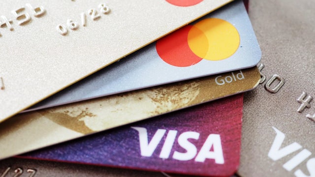 In this photo illustration, a stack of assorted Visa and 