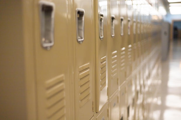 diminishing perspective of row of traditional metal school lockers 