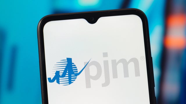 In this photo illustration, the PJM Interconnection logo is 