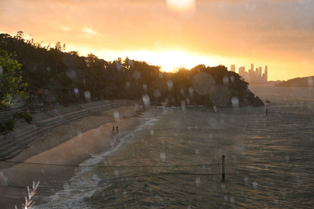 A view of rainfall over Shark Beach at sunset 