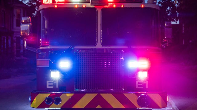 Front of Firetruck with Lights on at Dusk 