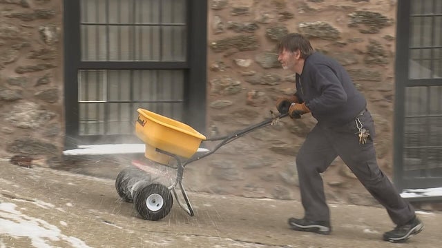 A man pushes a cart of rock salt up a hill in Manayunk 