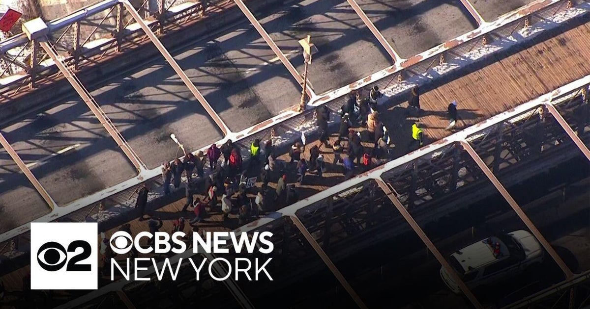 Anti-ICE protesters march across Brooklyn Bridge on MLK Day