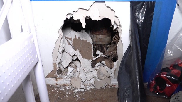 A large hole in the wall of a closet 