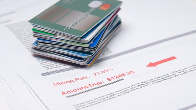 Stack of credit cards on account of value in red 