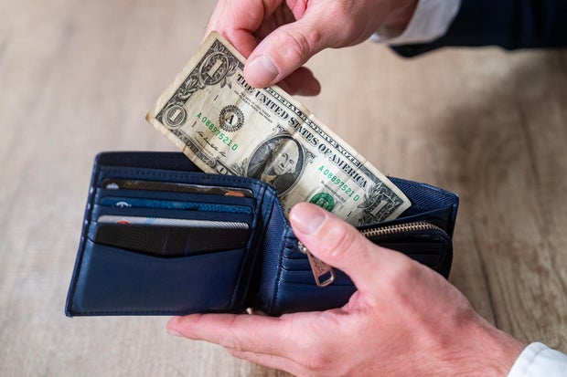 Person Handling Cash and Cards in Blue Leather Wallet 