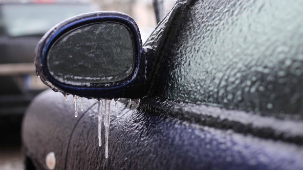 Car frozen side mirror after freezing rain 