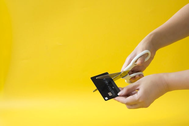 Hand cutting credit card - stock photo.