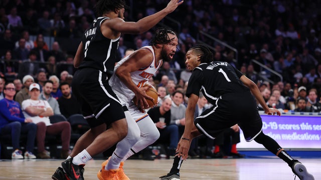 Jalen Brunson #11 of the New York Knicks looks to pass as Cam Thomas #24 and Ziaire Williams #1 of the Brooklyn Nets defend during the first half at Madison Square Garden on January 21, 2026 in New York City. 