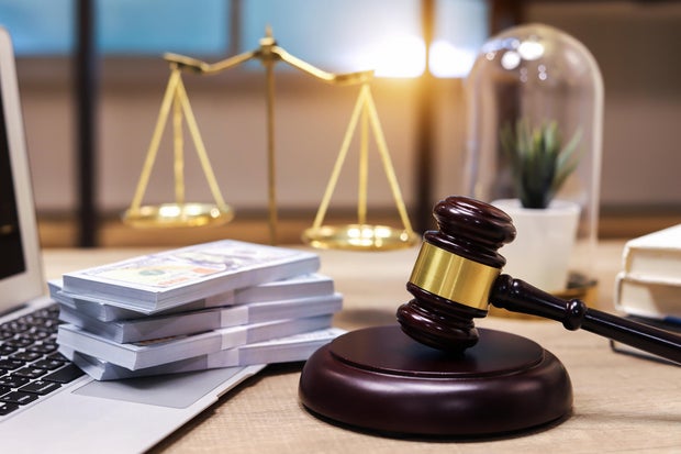 US paper currency on Laptop and gavel,Money with a hammer