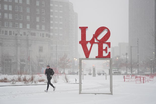 A person runs through LOVE Park near the LOVE statue in Philadelphia 