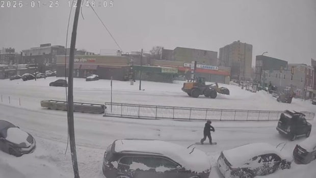 A snowboard is pulled behind a car on Girard Avenue in North Philadlephia 