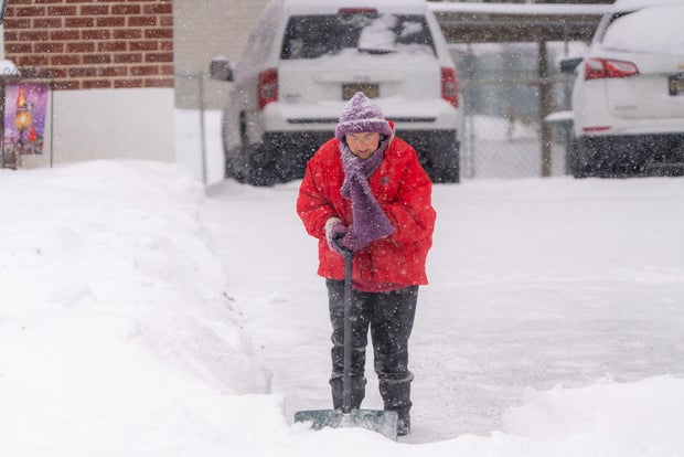 A person shovels in Hockessin, Delaware, as snow continues to fall 