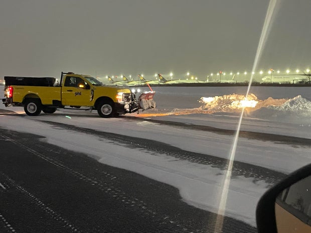 A plow works on a runway at PHL 