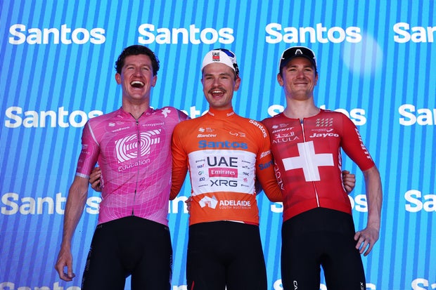 From left, third-place finisher Harry Sweeny of Australia and Team EF Education - EasyPost, race winner Jay Vine of Australia and UAE Team Emirates, and second-place finisher Mauro Schmid of Switzerland and Team Jayco AlUla pose on the podium ceremony after the Tour Down Under on Jan. 25, 2026, in Stirling, Australia. 