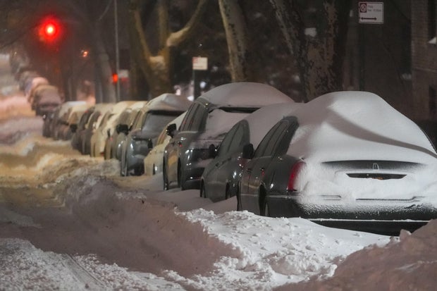 Snow buries cars on a street in New York City on Jan. 25, 2026. 