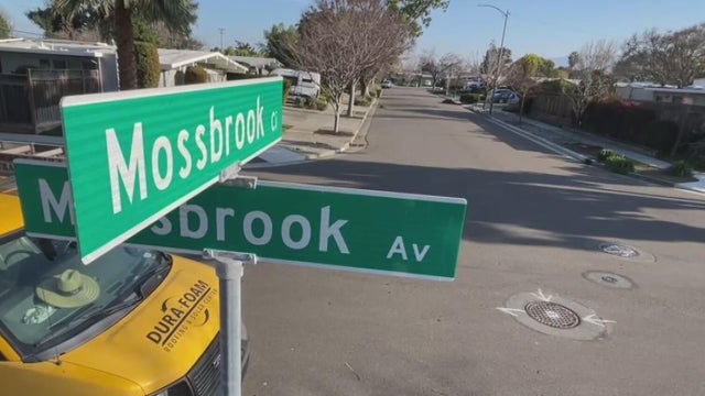 A street sign that reads Mossbrook Circle 