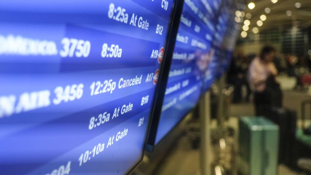 Travelers At Detroit Metro Airport Ahead Of Severe Winter Storm 