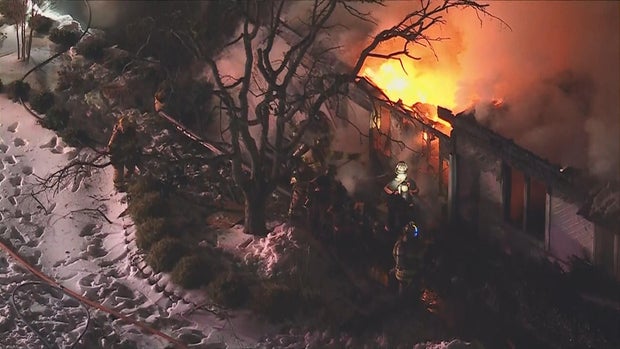 Firefighters are shown battling a fire at a home in this image from Chopper 3