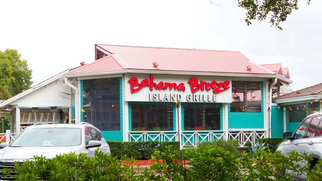 Bahama Breeze Island Grille restaurant exterior view with vibrant colors and tropical ambiance in the background 