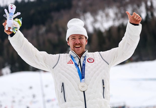 Silver medalist Ben Ogden of Team USA celebrates on the podium for the men's sprint cross-country skiing at the Tesero Cross-Country Skiing Stadium in Lago, Italy, on February 10, 2026. 