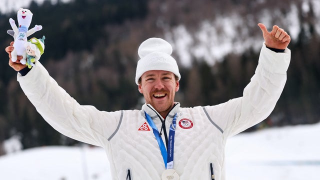 Silver medalist Ben Ogden of Team USA celebrates on the podium for the men's cross-country sprint at the Tesero Cross-Country Skiing Stadium in Lago, Italy, Feb. 10, 2026. 