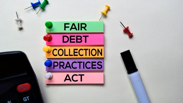 Fair Debt Collection Practices Act - FDCPA text on sticky notes isolated on office desk 