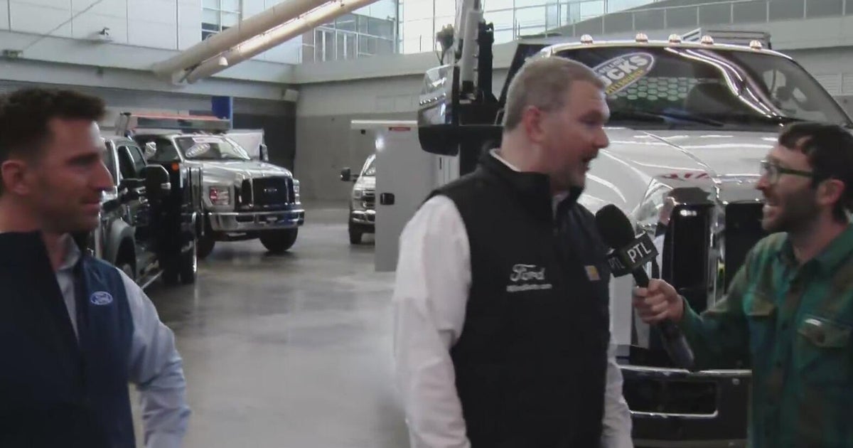 Boaz looks at a display of Ford pro commercial vehicles