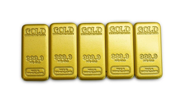 Gold bars 99.99% on a white background