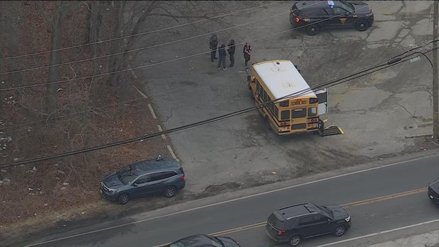 Overhead image of the school bus, a police car and some first responders