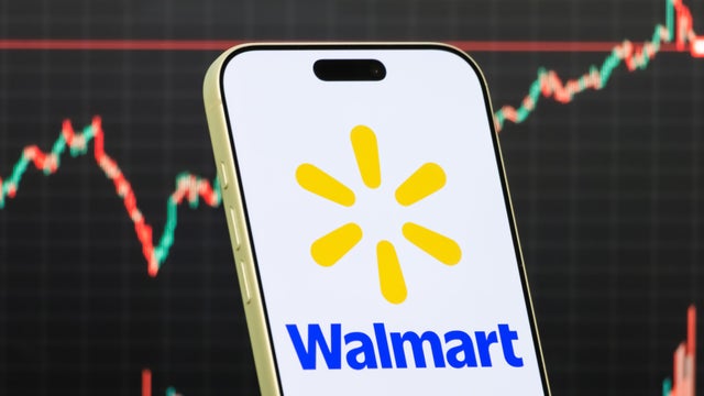 Walmart Logo Shown on Smartphone with Latest Stock Market Chart 
