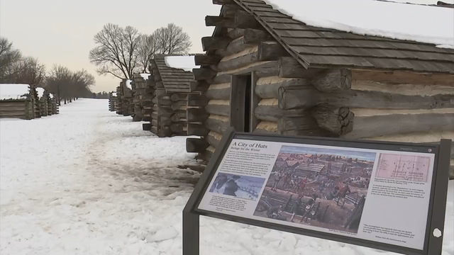 A hut for soldiers and an informational sign at Valley Force National Historical Park 