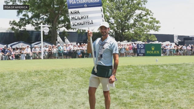 A volunteer holds up a sign during a prior PGA Championship 