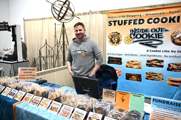 People pose for a photo at the opening day of the Philly Home and Garden show 