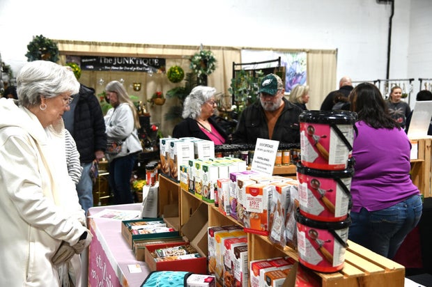 People pose for a photo at the opening day of the Philly Home and Garden show 
