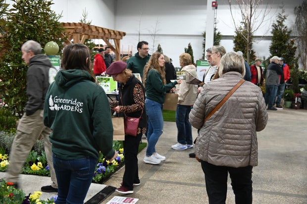 People pose for a photo at the opening day of the Philly Home and Garden show 