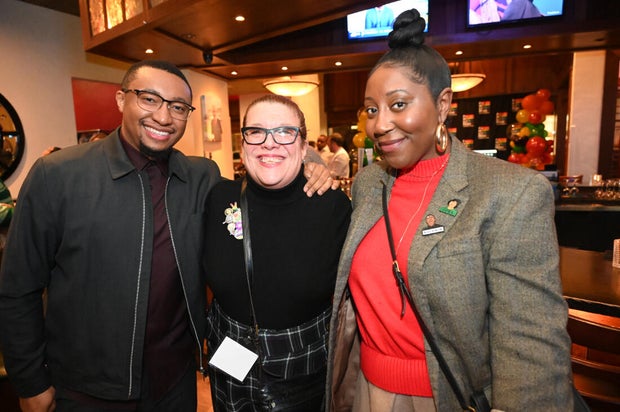 People pose for a photo at the opening of the Philly LGBTQ+ visitor center 
