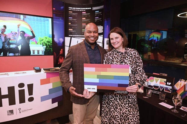 People pose for a photo at the opening of the Philly LGBTQ+ visitor center 