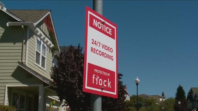 a street sign that says there is 24/7 video recording in the area by Flock cameras 
