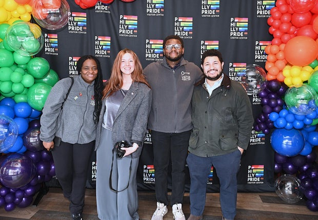 People pose for a photo at the opening of the Philly LGBTQ+ visitor center 