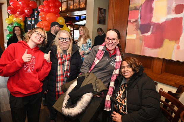 People pose for a photo at the opening of the Philly LGBTQ+ visitor center 