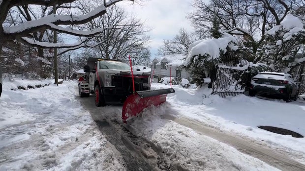 Snow plow on snowy street 